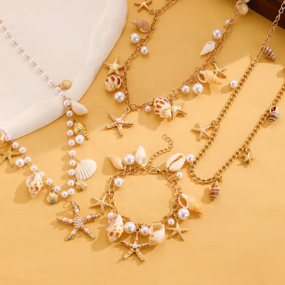 Schmuck-Set für Damen ⎜ Kette und Armband mit Muscheln, Perlen und Seesternen für sommerliche Strandlooks